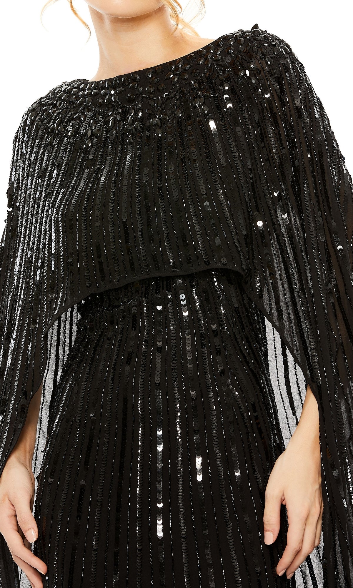 A person wearing the Mac Duggal 93869 Caped Long Sequin Formal Dress, a black gown with vertical sequin rows and draped, cape-like shoulder detailing.